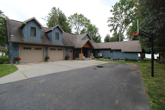 2150 Danish Landing Rd, Grayling, MI 49738 - view of front facade with concrete driveway and board and batten siding