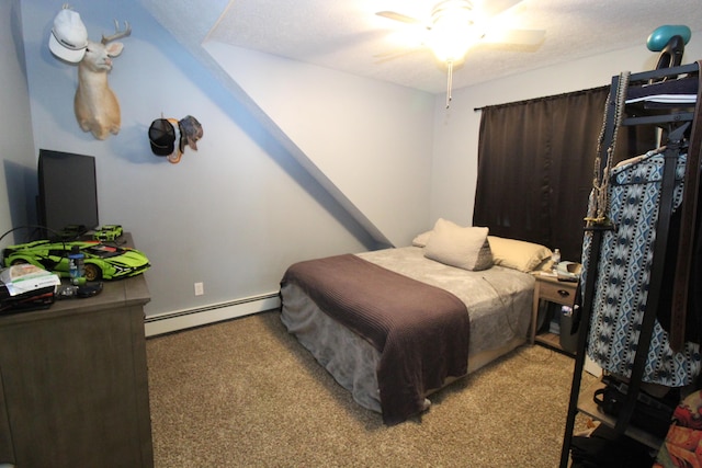 2150 Danish Landing Rd, Grayling, MI 49738 - carpeted bedroom featuring a baseboard radiator and ceiling fan