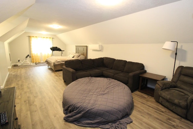 2150 Danish Landing Rd, Grayling, MI 49738 - bedroom featuring vaulted ceiling, wood finished floors, and a wall unit AC