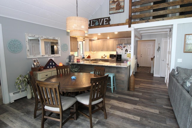 2150 Danish Landing Rd, Grayling, MI 49738 - dining space with baseboard heating, dark wood-style floors, and vaulted ceiling