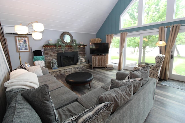 2150 Danish Landing Rd, Grayling, MI 49738 - living room with wood finished floors, lofted ceiling, and a stone fireplace