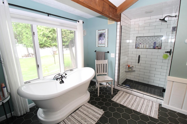 2150 Danish Landing Rd, Grayling, MI 49738 - bathroom with healthy amount of natural light, a shower stall, a freestanding tub, beamed ceiling, and tile patterned flooring