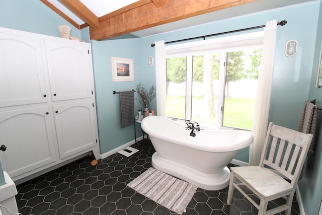 2150 Danish Landing Rd, Grayling, MI 49738 - full bath with a freestanding tub, beamed ceiling, and tile patterned flooring