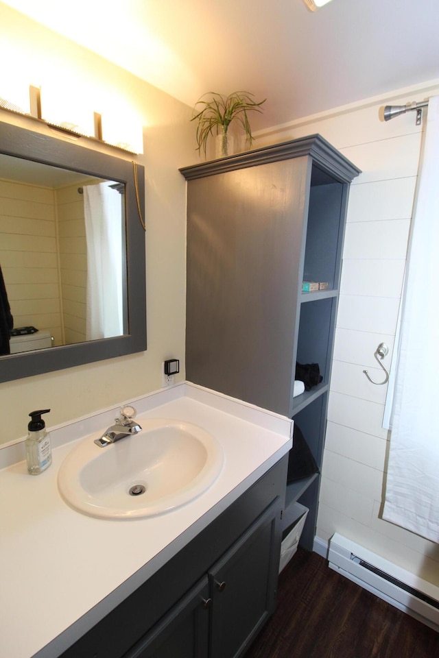 2150 Danish Landing Rd, Grayling, MI 49738 - full bathroom with baseboard heating, vanity, a tile shower, and wood finished floors