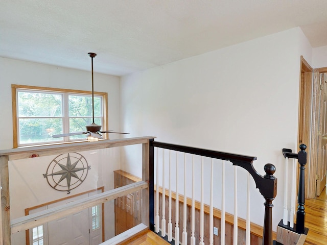 7090 Nancy K Dr, Hale, MI 48739 - stairs with plenty of natural light, wood finished floors, and a ceiling fan