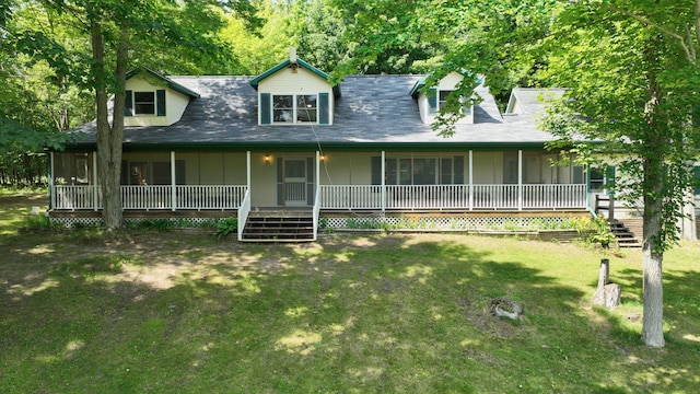 7090 Nancy K Dr, Hale, MI 48739 - view of front of home featuring stairs, a front yard, and a sunroom