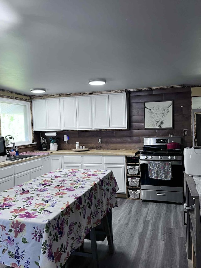4130 Werth Rd, Alpena, MI 49707 - kitchen with stainless steel gas range, white cabinets, light countertops, and wood finished floors