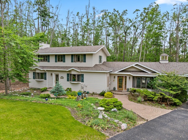 982 Shaggy Bark Ct, Gaylord, MI 49735 - view of front facade featuring a chimney, a front lawn, and a shingled roof