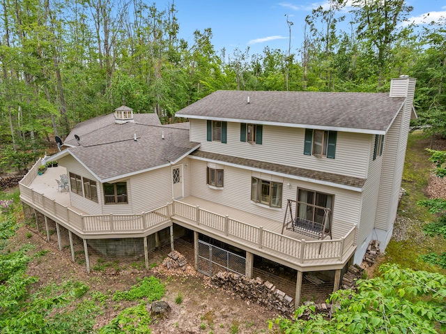 982 Shaggy Bark Ct, Gaylord, MI 49735 - rear view of property with a shingled roof, a deck, and a chimney