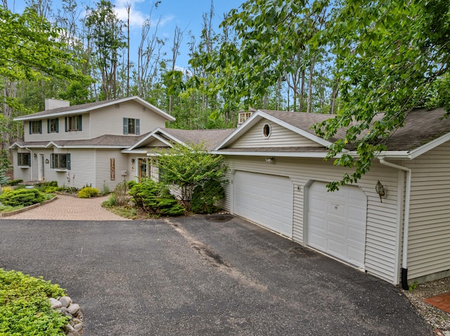 982 Shaggy Bark Ct, Gaylord, MI 49735 - view of front of property featuring driveway, a garage, and roof with shingles
