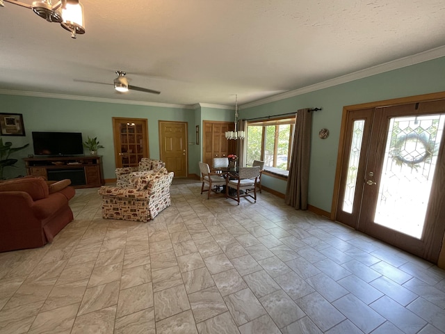 982 Shaggy Bark Ct, Gaylord, MI 49735 - living area featuring crown molding, ceiling fan, and a chandelier