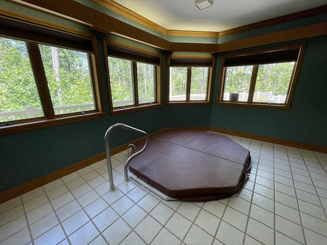 982 Shaggy Bark Ct, Gaylord, MI 49735 - sunroom / solarium with plenty of natural light, tile patterned floors, and crown molding