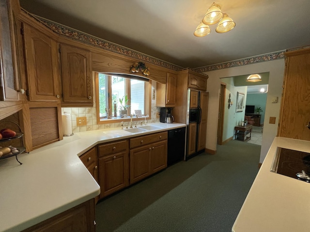 982 Shaggy Bark Ct, Gaylord, MI 49735 - kitchen with black appliances, backsplash, light countertops, and carpet