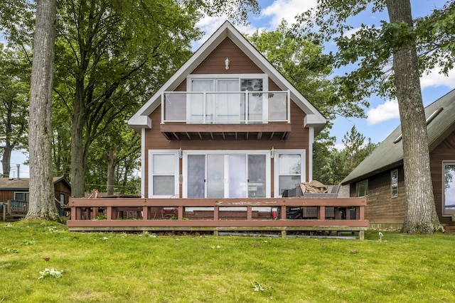 3974 W Houghton Lake Dr, Houghton Lake, MI 48629 - rear view of house featuring a balcony, a yard, and a deck