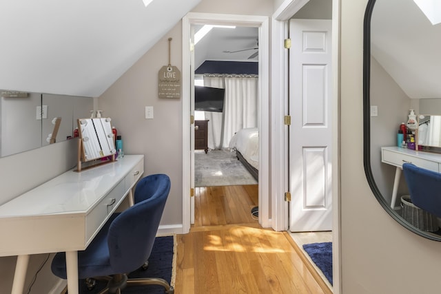 3974 W Houghton Lake Dr, Houghton Lake, MI 48629 - home office featuring vaulted ceiling, wood finished floors, and a skylight