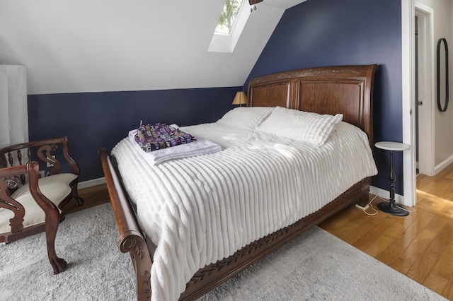 3974 W Houghton Lake Dr, Houghton Lake, MI 48629 - bedroom featuring a skylight, wood finished floors, and vaulted ceiling