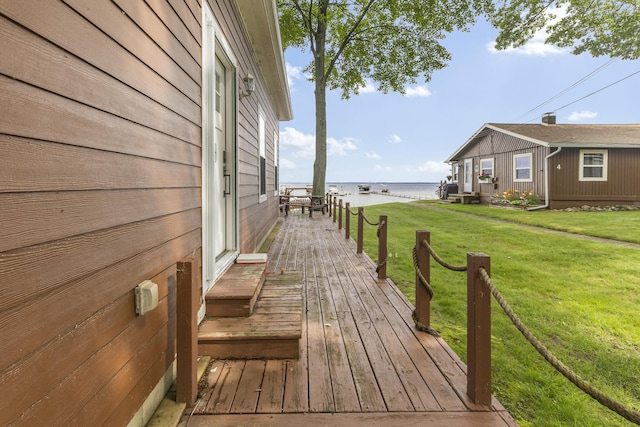 3974 W Houghton Lake Dr, Houghton Lake, MI 48629 - wooden terrace with a water view and a yard