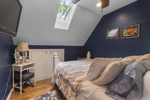 3974 W Houghton Lake Dr, Houghton Lake, MI 48629 - bedroom with a skylight, wood finished floors, and vaulted ceiling
