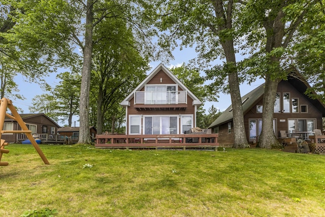 3974 W Houghton Lake Dr, Houghton Lake, MI 48629 - rear view of house featuring a balcony, a yard, and a deck