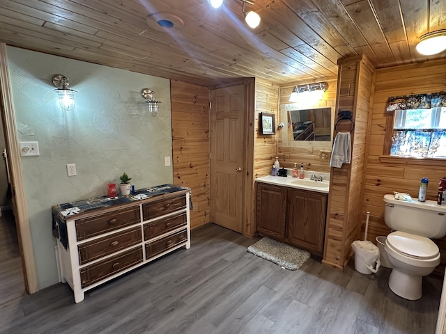 5127 Crestwood Rd, Lewiston, MI 49756 - bathroom with wood ceiling, vanity, wood finished floors, and wooden walls
