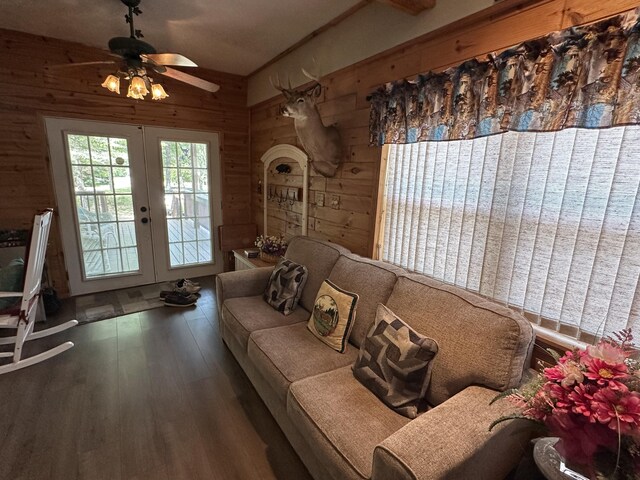 5127 Crestwood Rd, Lewiston, MI 49756 - living room featuring wood walls, french doors, wood finished floors, and a ceiling fan