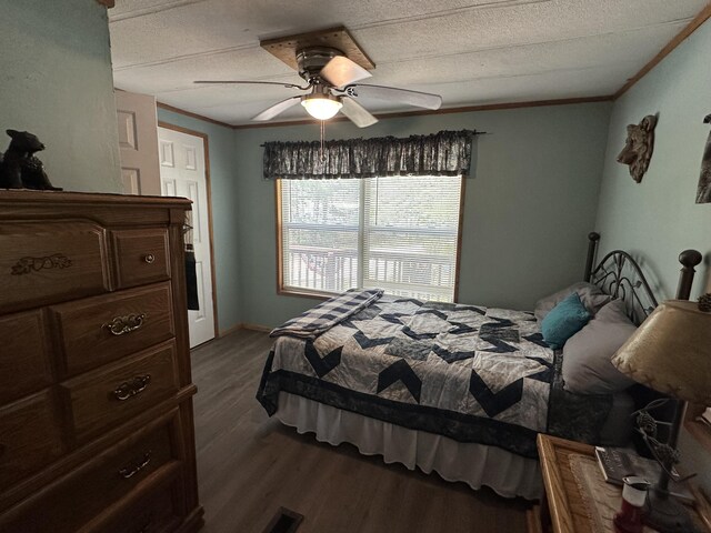 5127 Crestwood Rd, Lewiston, MI 49756 - bedroom featuring dark wood finished floors, a ceiling fan, and ornamental molding