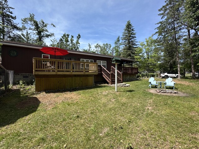 5127 Crestwood Rd, Lewiston, MI 49756 - back of house with a wooden deck, a yard, and stairway