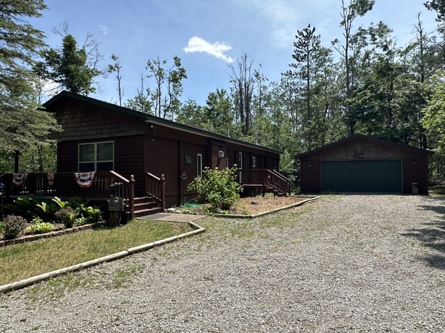 5127 Crestwood Rd, Lewiston, MI 49756 - ranch-style home with an outdoor structure, a detached garage, and a wooden deck