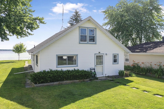 12328 W Shore Dr, Houghton Lake, MI 48629 - back of house featuring a lawn and a water view