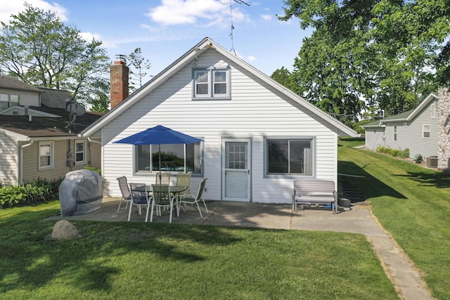 12328 W Shore Dr, Houghton Lake, MI 48629 - back of property featuring a patio, a yard, and a chimney
