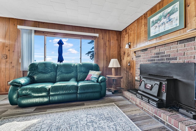 12328 W Shore Dr, Houghton Lake, MI 48629 - living area featuring wooden walls, wood finished floors, and a wood stove