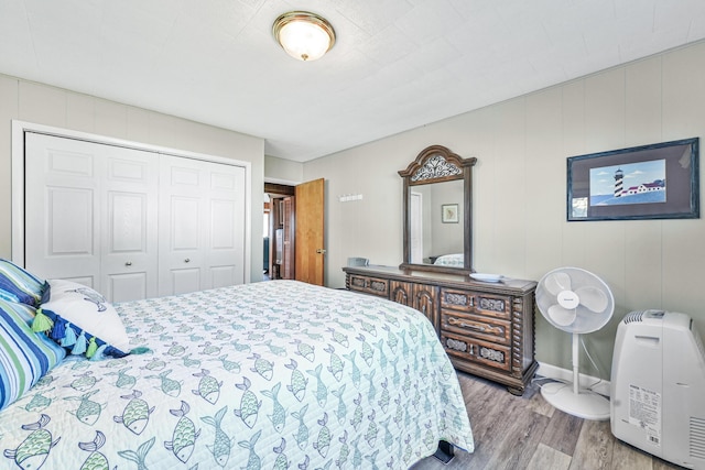 12328 W Shore Dr, Houghton Lake, MI 48629 - bedroom with wood finished floors and a closet