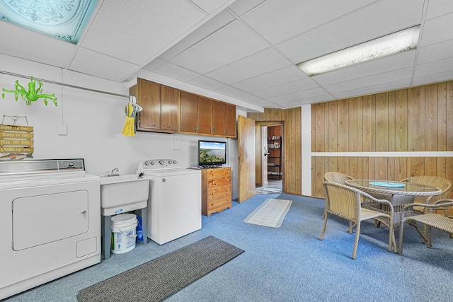 12328 W Shore Dr, Houghton Lake, MI 48629 - laundry room with washer and dryer, carpet flooring, wooden walls, and cabinet space