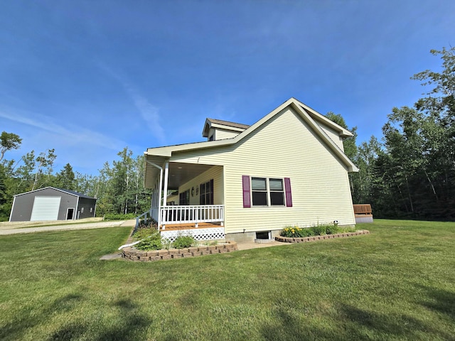 N705 Woods Rd, Saint Ignace, MI 49781 - view of home's exterior with a lawn, a garage, and a porch