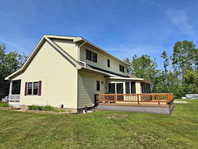 N705 Woods Rd, Saint Ignace, MI 49781 - rear view of house with a sunroom, a yard, and a wooden deck