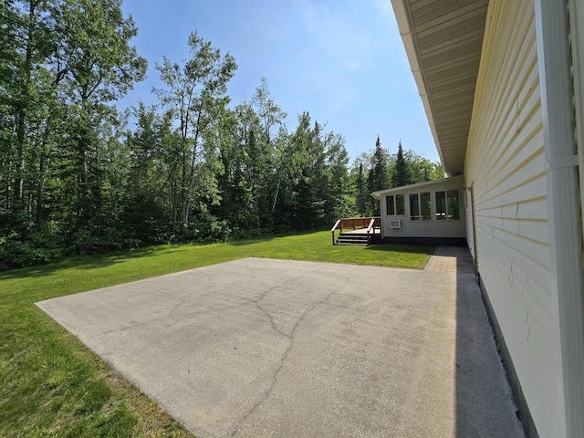 N705 Woods Rd, Saint Ignace, MI 49781 - view of patio / terrace with a wooden deck and a view of trees