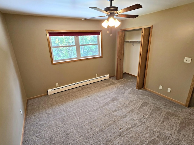 N705 Woods Rd, Saint Ignace, MI 49781 - unfurnished bedroom with a baseboard heating unit, light colored carpet, a closet, and ceiling fan