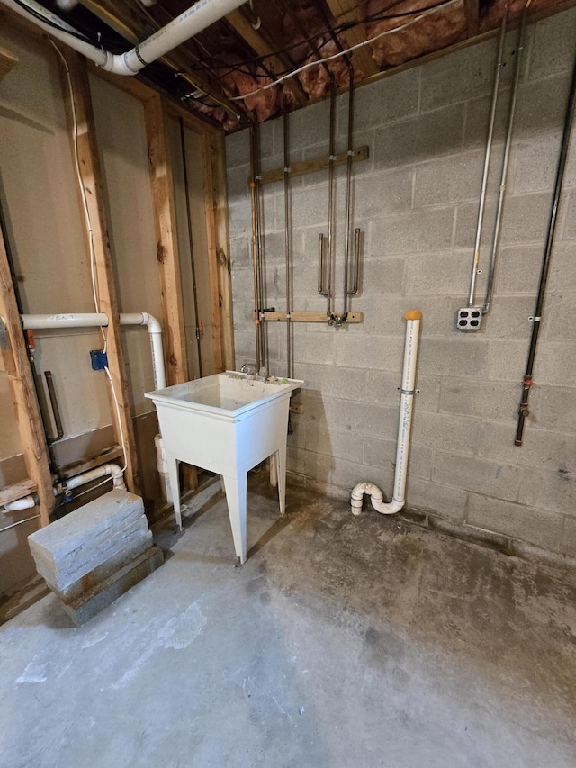 N705 Woods Rd, Saint Ignace, MI 49781 - unfinished below grade area featuring concrete block wall and a sink