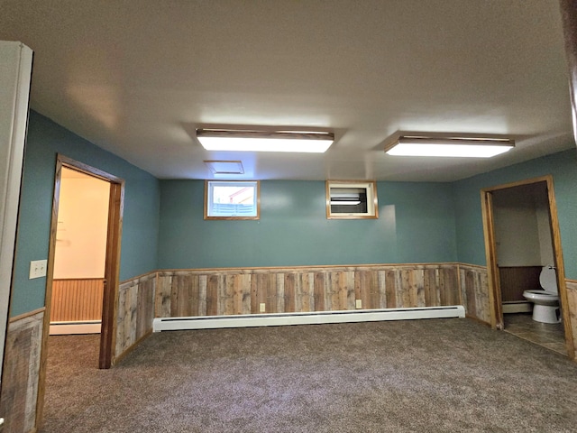 N705 Woods Rd, Saint Ignace, MI 49781 - basement with carpet, wainscoting, baseboard heating, and wooden walls