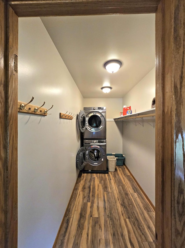 N705 Woods Rd, Saint Ignace, MI 49781 - laundry area featuring stacked washer / dryer and wood finished floors