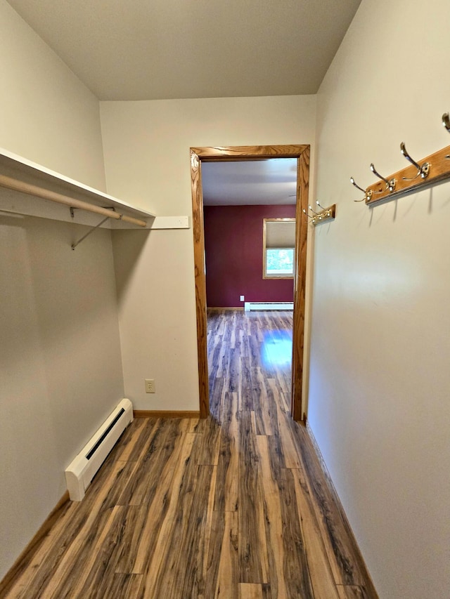 N705 Woods Rd, Saint Ignace, MI 49781 - walk in closet with a baseboard heating unit and wood finished floors