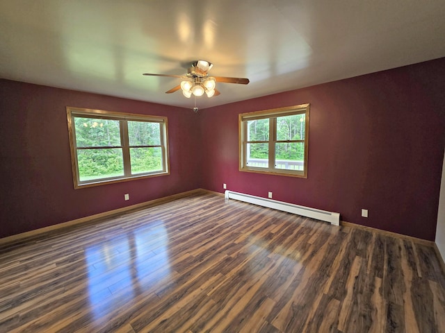 N705 Woods Rd, Saint Ignace, MI 49781 - unfurnished room with a baseboard radiator, plenty of natural light, a ceiling fan, and wood finished floors