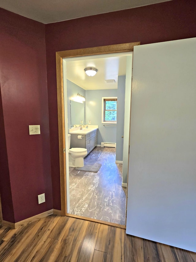 N705 Woods Rd, Saint Ignace, MI 49781 - hallway with wood finished floors and baseboard heating