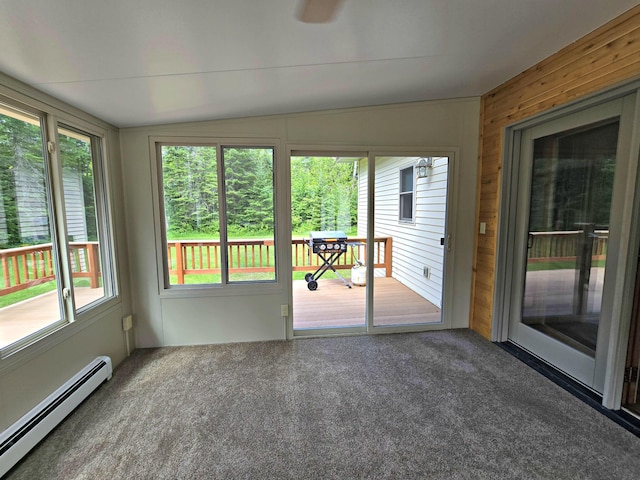 N705 Woods Rd, Saint Ignace, MI 49781 - unfurnished sunroom featuring baseboard heating, lofted ceiling, plenty of natural light, carpet, and wood walls