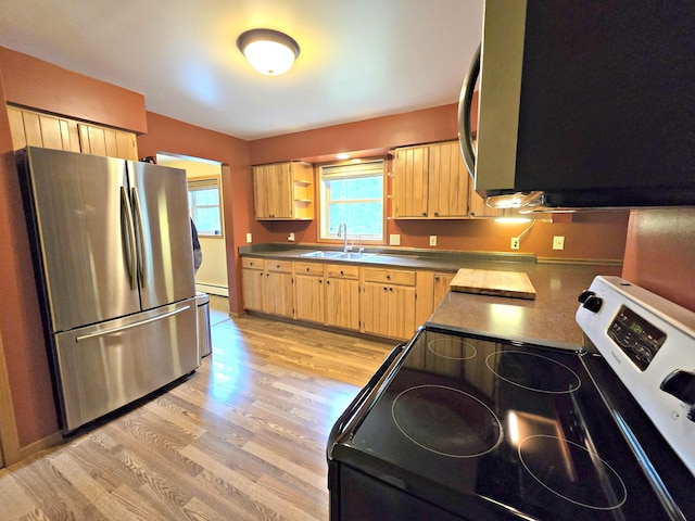 N705 Woods Rd, Saint Ignace, MI 49781 - kitchen with stainless steel appliances, light wood-style flooring, light brown cabinetry, and a baseboard heating unit
