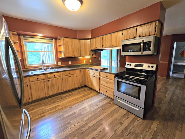 N705 Woods Rd, Saint Ignace, MI 49781 - kitchen with appliances with stainless steel finishes, dark wood finished floors, open shelves, and dark countertops