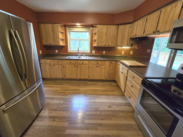 N705 Woods Rd, Saint Ignace, MI 49781 - kitchen featuring stainless steel appliances, open shelves, wood finished floors, and healthy amount of natural light