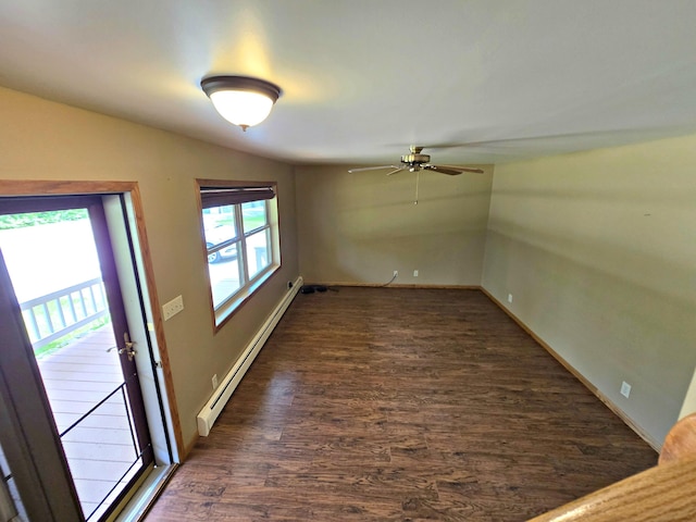 N705 Woods Rd, Saint Ignace, MI 49781 - empty room with a baseboard radiator, a ceiling fan, dark wood-style flooring, and vaulted ceiling