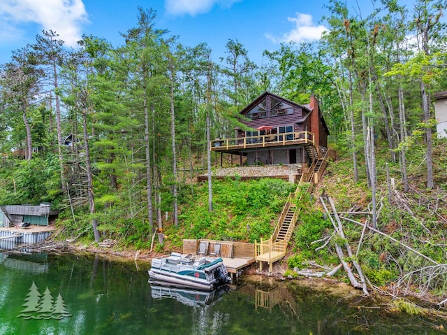 6609 Honey Ln, Johannesburg, MI 49751 - rear view of property featuring stairs, a chimney, and a deck with water view