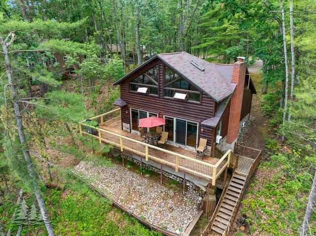 6609 Honey Ln, Johannesburg, MI 49751 - back of property featuring faux log siding, a chimney, a wooden deck, and stairs